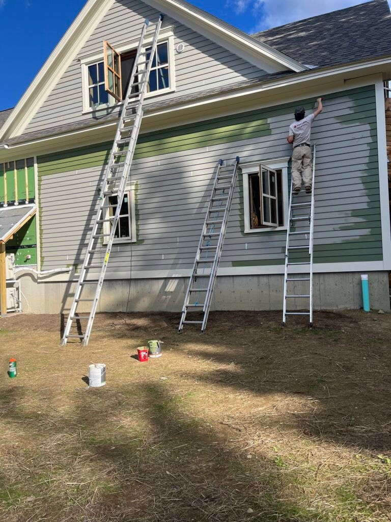Paintable crew painting a Vermont home exterior
